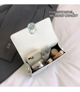 Interior view of white crossbody bag showing spacious storage for makeup and smartphone