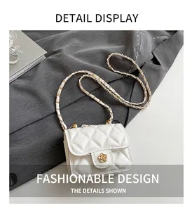 Detail of white quilted crossbody bag with a golden floral clasp on a textured suit jacket
