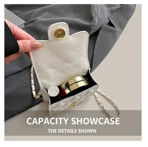 Detail of the compact interior capacity of the white quilted mini chain bag