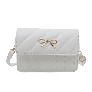 White quilted crossbody bag with gold bow detail and adjustable shoulder strap
