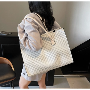 Lifestyle view showing the large capacity tote bag with M-pattern on a female model