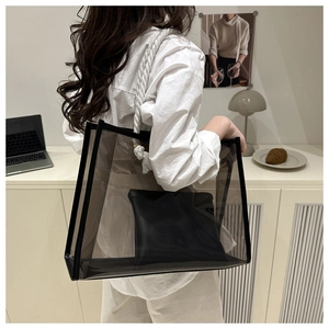 Detail of transparent PVC tote bag with rope handles and black inner pouch for women