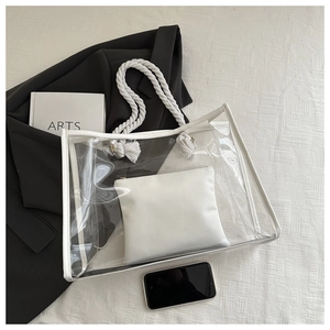 Detail of transparent PVC tote bag with white rope handle and inner leather pouch