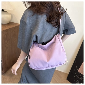 Detail view of lavender canvas shoulder bag showing soft waterproof fabric and stitching