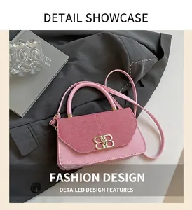 Close-up of pink crossbody bag featuring gold BB metal buckle and ribbed texture flap
