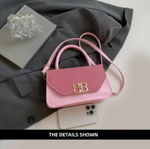 Pink shoulder bag detail showing glossy leather texture and gold metal BB logo clasp
