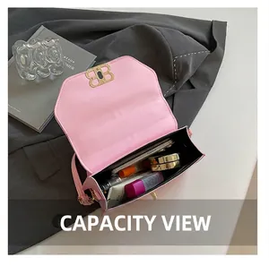 Top view of pink leather handbag interior showing storage for phone and cosmetics