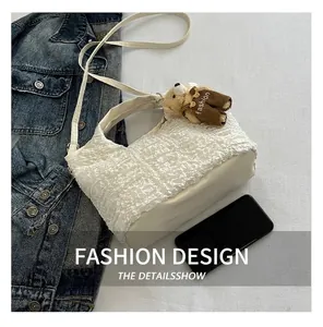Detail showing white bubble texture fabric with leather bottom and a cute bear charm