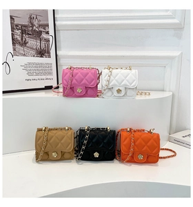 Detailed macro view of five colorful mini quilted PU leather bags with floral gold buckles