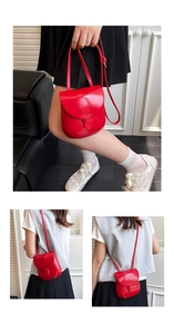 Detail of red glossy patent leather shell bag with adjustable strap and buckle closure