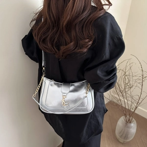 Silver crescent moon shoulder bag with golden chain strap and metallic hook closure