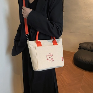 Minimalist canvas bucket tote bag with orange straps and a cute cartoon bear print