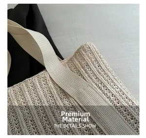 Close-up detail of high-quality woven straw texture and durable strap on a beige summer bag