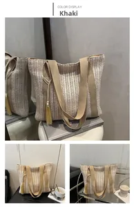 Detail of khaki woven straw tote bag with elegant tassel charm for beach and commute