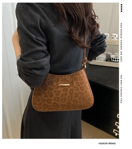 Detailed view of leopard print shoulder bag with suede texture and golden metal buckle