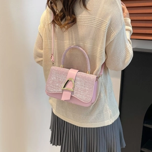 Pink glitter women's small flap bag with golden horsebit buckle and long shoulder strap