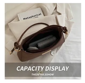 Interior view showing the large capacity and zipper pocket of the dark brown shoulder bag