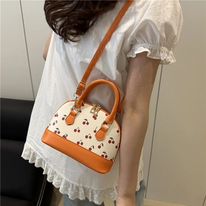 Fashionable shell-shaped tote bag with red cherry prints and orange contrast handles