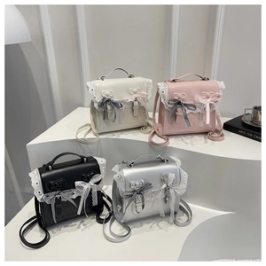 Detailed view of small faux leather backpacks with lace trim and checkered bows in four colors