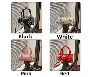 Boston bags in black, white, pink, and red with classic polka dot pattern details