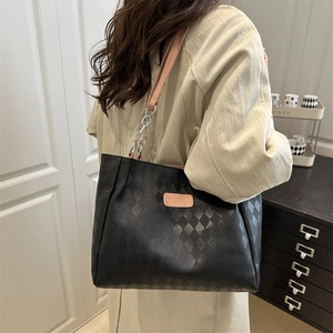 Large black quilted tote bag with pink chain strap for chic office commuting