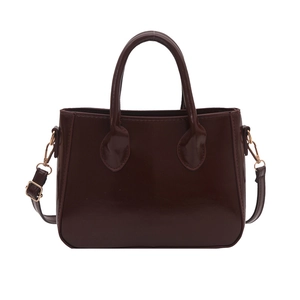 Minimalist dark brown patent leather satchel with golden hardware and shoulder strap