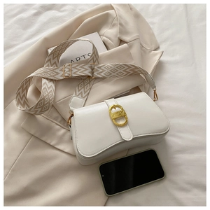 Detail of white PU leather crossbody bag featuring a golden D-shaped buckle and woven strap