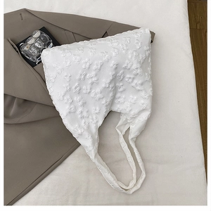 Detail of white 3D floral lace embroidery on a large canvas tote bag for women
