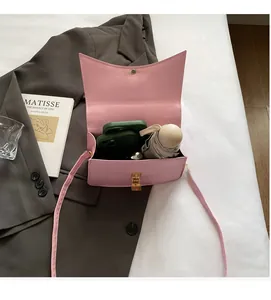Interior detail of pink leather crossbody bag showing large capacity for phone and umbrella