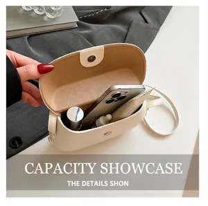 Minimalist cream square crossbody bag showing interior space for phone and cosmetics