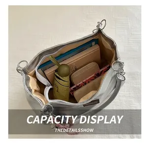 Top view of a large silver tote bag showing interior space with a laptop and daily essentials