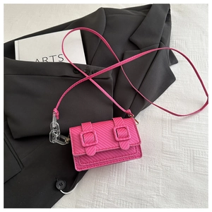 Pink mini crossbody bag featuring diagonal embossing and acrylic chain strap detail