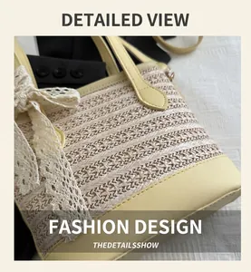 Detail of straw woven bucket bag featuring yellow leather trim and a white lace bow detail