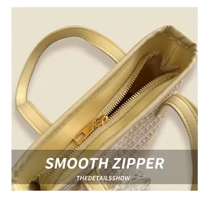 Close-up of golden metal zipper closure and interior lining on straw bucket bag