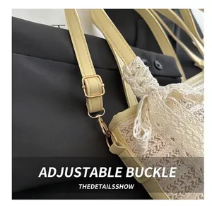 Detail of adjustable metal buckle and woven texture on a straw beach bucket bag