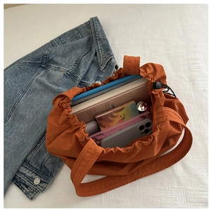 Makroansicht einer orangefarbenen Kordelzug-Tasche mit viel Platz für tägliche Gegenstände