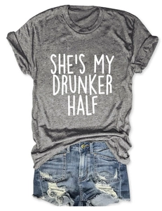 Detailed texture of grey t-shirt with She's My Drunker Half print and denim shorts
