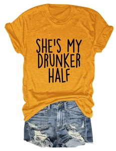 Flat lay of yellow T-shirt with 'SHE'S MY DRUNKER HALF' text and denim shorts