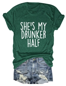 Detailed flat lay of a dark green crew neck T-shirt with 'SHE'S MY DRUNKER HALF' print