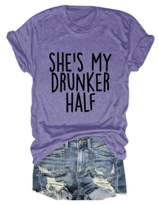 Detail of purple crewneck T-shirt with text print and distressed denim shorts