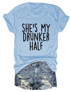 Flat lay of light blue cotton T-shirt with 'SHE'S MY DRUNKER HALF' print and denim shorts