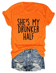 Detail of orange crew neck T-shirt with She's My Drunker Half print and ripped denim shorts