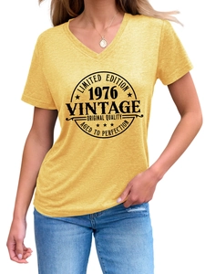 Close-up of V-neckline and 1976 Vintage graphic on yellow short-sleeve cotton T-shirt