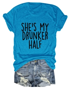 Flat lay of royal blue t-shirt with black text print and ripped denim shorts set