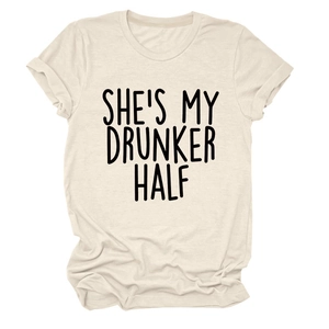 Close-up of cream cotton t-shirt featuring She’s My Drunker Half text and rolled sleeves