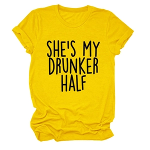 Detail of yellow cotton T-shirt featuring 'SHE'S MY DRUNKER HALF' slogan text and rolled sleeves