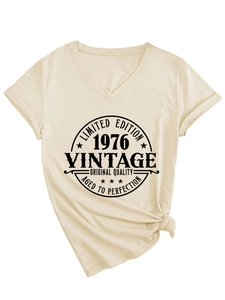 Detail of beige V-neck T-shirt showing vintage 1976 print and stylish front hem knot
