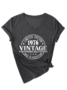 Detailed view of women's dark grey V-neck T-shirt with vintage 1976 print and knotted hem