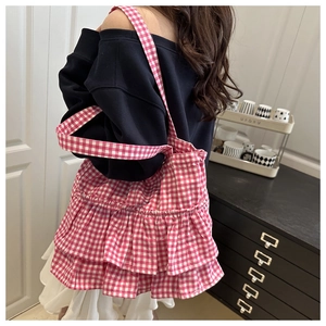 Detail of pink plaid tote bag with triple-layered ruffle design for a sweet summer look