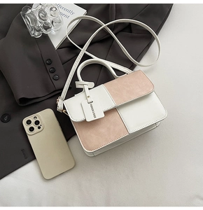 Chic pink and white contrast leather handbag styled with business attire accessories